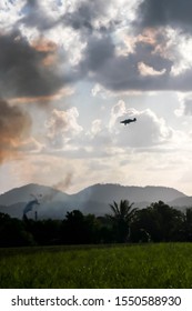 Fire On The East Coast Of Queensland, Australia With An Airplane Flying Overhead.