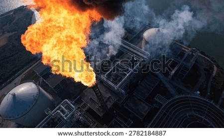 Fire on flare stack at refinery oil and gas central processing platform while burning toxic and release over pressure. gas flare at an oil refinery factory industrial. Aerial view.