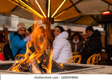 Fire on a table outside in the winter. Aprés Ski and lucky people.