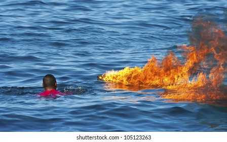 Fire on water with rescuing man
