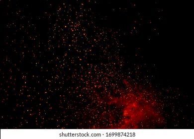 Fire particles effect dust debris isolated on black background, motion powder spray burst. fire flames with sparks. Burning red hot sparks fly from large fire in the night sky.  light and life.