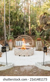 Fire Pit Bonfire Campsite In Tropical Backyard Woods With Rustic Wooden Branch Chairs Twinkle Lights Lantern Candles Palm Trees Stump Tables In Florida At Sunset