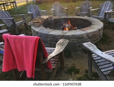 Fire Pit Surrounded By Adirondack Chairs Ready For A Party