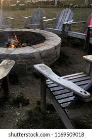 Fire Pit Surrounded By Adirondack Chairs Ready For A Party