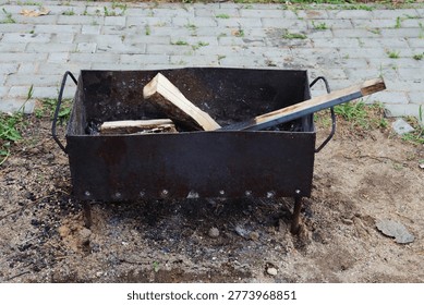  The fire pit is surrounded by bricks and has a hole in the ground