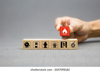 Fire prevention, Cube wooden toy block stack with prevent icon with door exit sing or fire escape with fire extinguisher and emergency protection symbol for safety and rescue in the building. - Shutterstock ID 2047098182