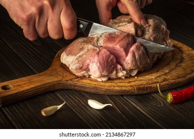 For Fire, Raw Meat Must Be Cut Into Small Pieces. Hands Of A Chef With A Knife In The Kitchen. Cooking Delicious Food For A Restaurant.