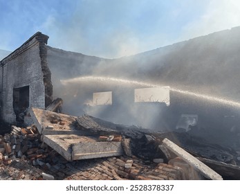 A fire in a ruined and abandoned building. The walls and roof have collapsed, and rubble is burning inside. - Powered by Shutterstock