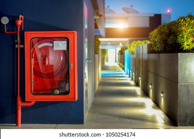 Fire Safety Concept, Fire Extinguisher And Fire Hose Reel In Public Building Corridor