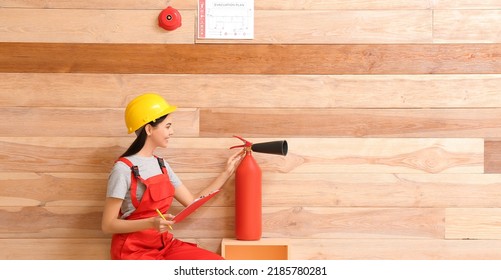Fire Safety Specialist Inspecting Extinguisher In Premises
