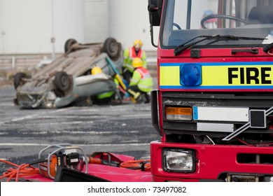 Fire Service Truck And Rescue Emergency Units At Car Crash