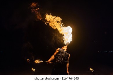 Fire show artist breathe fire in the dark jamp - Powered by Shutterstock