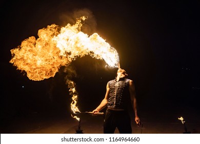 Fire show artist breathe fire in the dark jamp - Powered by Shutterstock