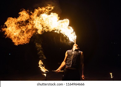 Fire show artist breathe fire in the dark jamp - Powered by Shutterstock