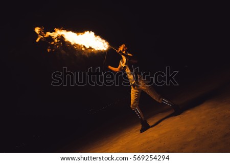 fire show, dancing with flame, male master fakir with fire works, performance outdoors, flame control man, a man in a suit LED dances with fire, draws a fiery figure in the dark Stock photo © 