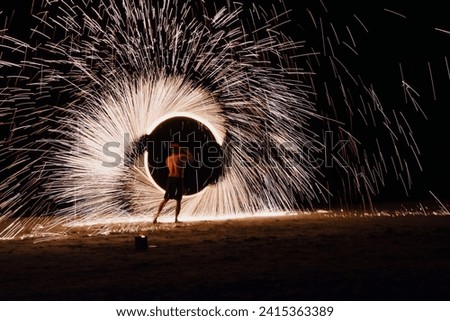 fire show on the night beach. long exposure photography. Long exposure fire marks