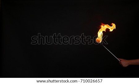Fire show performance. A man picks gasoline at a torch, slow motion.