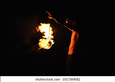 Fire show performance at night, flames in the dark