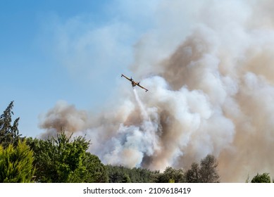 Fire Smoke In Blue Sky And Yellow Red Fire Plane Trying To Put It Out