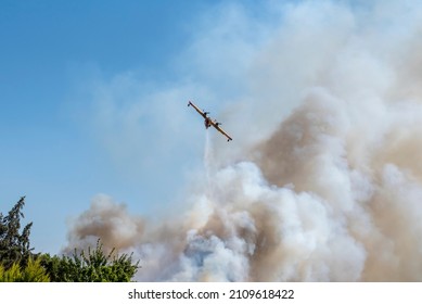 Fire Smoke In Blue Sky And Yellow Red Fire Plane Trying To Put It Out