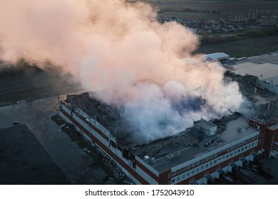 Fire with smoke industrial building, aerial view