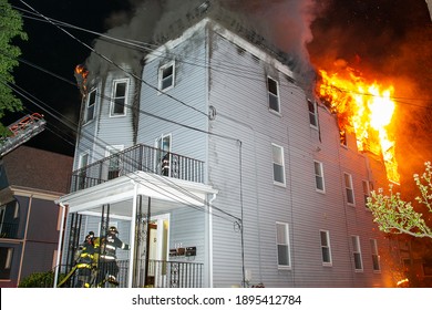 Fire And Smoke Pour From A 3 Story Multi Family House As Firefighters Attempt To Extinguish This Late Night Building Fire