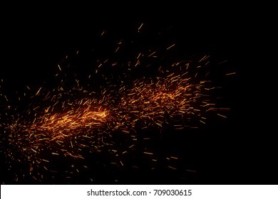 Fire sparks came from campfire isolated on black background for overlay design 