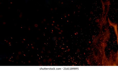 Fire sparks flying like particles on black background. Abstract background.