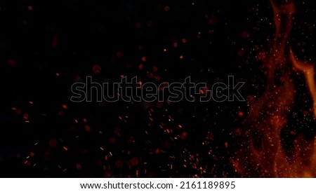 Fire sparks flying like particles on black background. Abstract background.