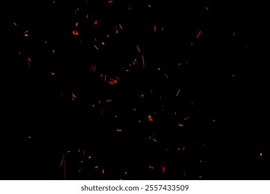 Fire sparks particles with flames isolated on black background.