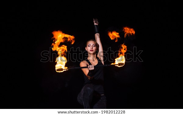Fire and sparks.\
Sexy woman twirl burning stick in darkness. Fire performance. Baton\
twirling. Juggling devil stick. Night party. Outdoor festival.\
Holiday celebration
