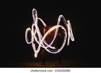 Fire Spinner Making Different Figures With Fire. Slow Motion Image. Fire Spinning