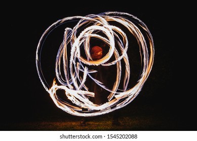 Fire Spinner Making Different Figures With Fire. Slow Motion Image. Fire Spinning