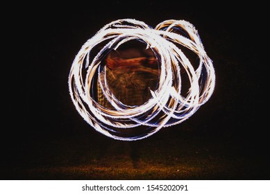 Fire Spinner Making Different Figures With Fire. Slow Motion Image. Fire Spinning