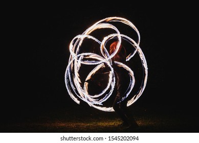 Fire Spinner Making Different Figures With Fire. Slow Motion Image. Fire Spinning