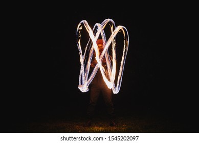 Fire Spinner Making Different Figures With Fire. Slow Motion Image. Fire Spinning