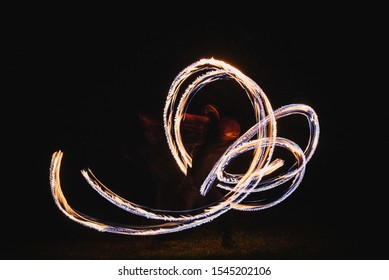 Fire Spinner Making Different Figures With Fire. Slow Motion Image. Fire Spinning