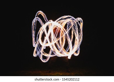 Fire Spinner Making Different Figures With Fire. Slow Motion Image. Fire Spinning