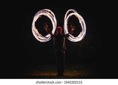 Fire Spinner Making Different Figures With Fire. Slow Motion Image. Fire Spinning