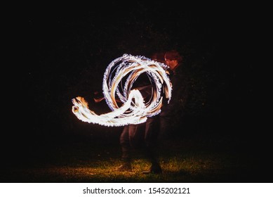 Fire Spinner Making Different Figures With Fire. Slow Motion Image. Fire Spinning