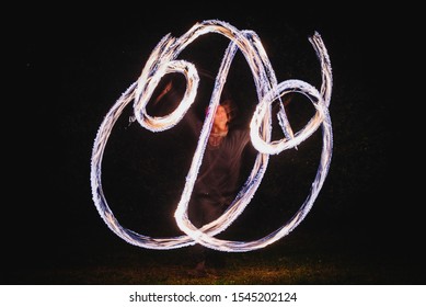 Fire Spinner Making Different Figures With Fire. Slow Motion Image. Fire Spinning