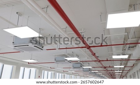 Fire sprinkler and red pipe.Install fire sprinkler system. In the industrial plant warehouse, pipe assembly, red fire pipe, fire protection contractors Using Scissor Lift High work