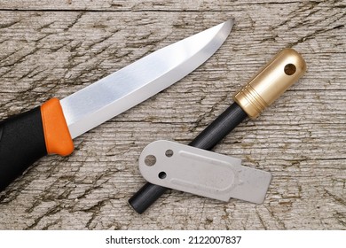 
Fire Starter And Camping Folding Knife On Grungy Wooden Background   