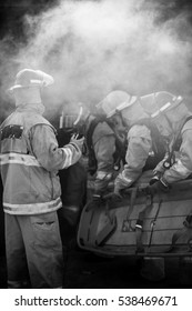 Fire team prepare to enter burning building with stretcher during training