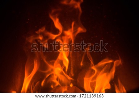 Fire Texture on dark background. Red Flames burning in oven. Abstract hot element.