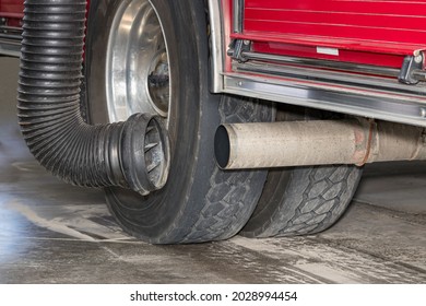 Fire Truck Exhaust Tailpipe With Diesel Fume Extractor Hose System. Concept Of Emission Control, Firefighter Health And Safety In Firehouse