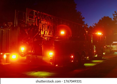 Fire truck with flashing red lights of a fire engine night time in dusk