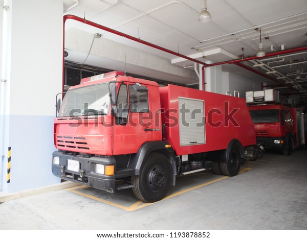 Fire truck parked at a fire station, Ready\
for action on a high fire danger\
day.