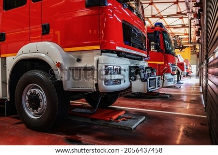 Fire trucks parked in fire brigade prepared for action.