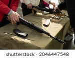 Firearm. Training in the possession of the machine. Lesson on the analysis of a firearm. A person learns to service automatic weapons.